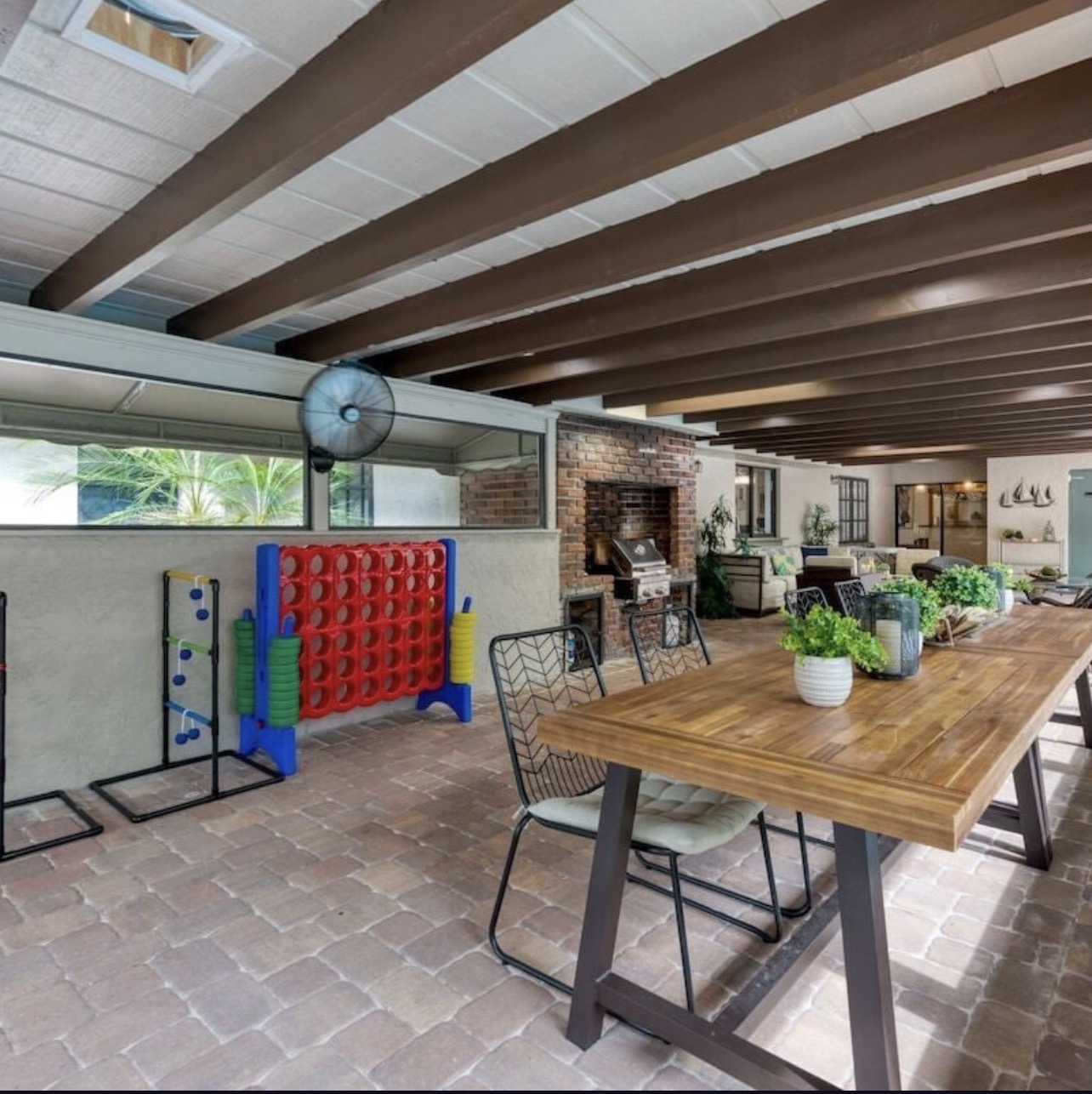 Covered game pavilion with fireplace, grill, and oversized games