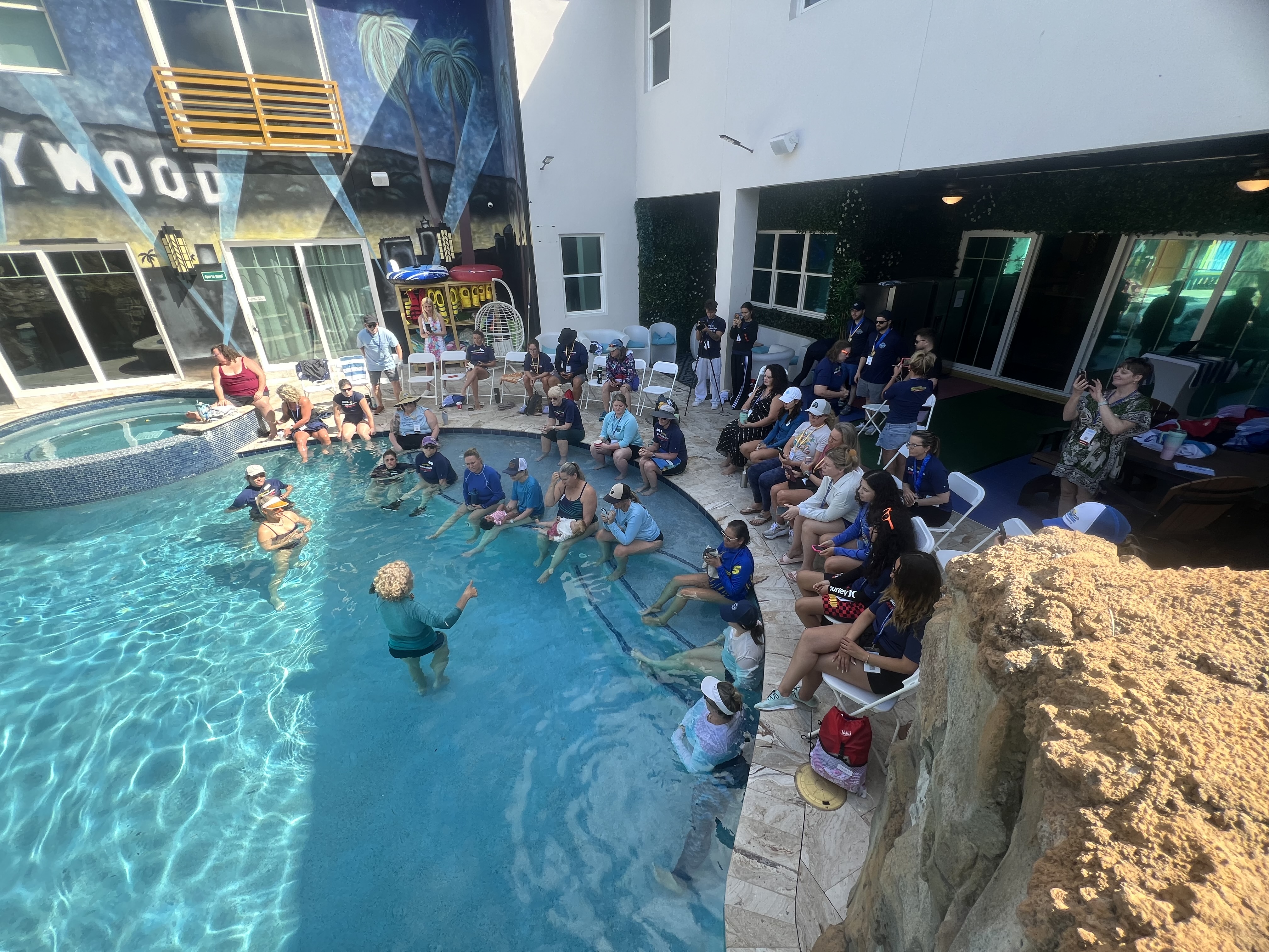 Indoor pool venue with audience watching demo